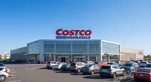 Costco Wholesale store with cars parked in the parking lot in front of it