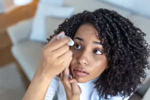 woman applying eye drops