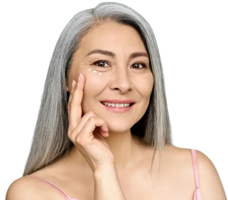 A woman is posing for a photo with her hand on her face and she is smiling