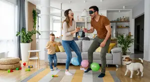 A man and woman play with their young son and dog in a modern living room with large windows and a neutral color palette.