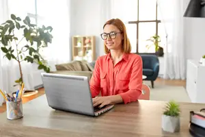 woman sitting at a desk using a laptop