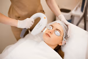 Woman receiving IPL light therapy treatment around the eyes