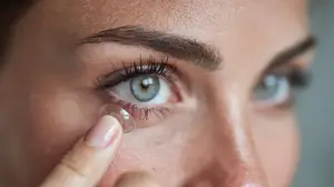 Close up of a woman's face with a clear contact lens on her eye