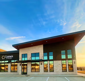 Exterior of a Lumen Eyecare building with a clear sky in the background