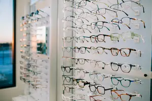 A wall displaying a variety of eyeglasses in different colors and styles