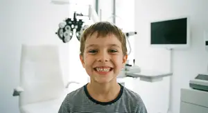 A young boy with a big smile at a dentist office
