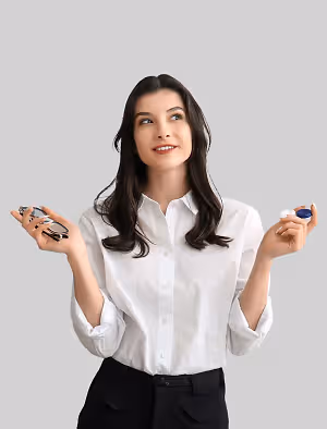 A smiling woman in a white shirt holding a pair of glasses and contact lenses