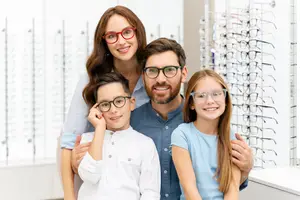 A family is in a store looking at eyeglasses.