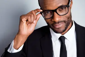 Business man adjusting glasses