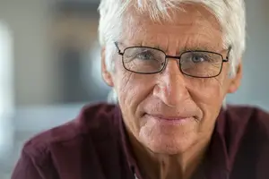 portrait of senior man wearing glasses and smiling