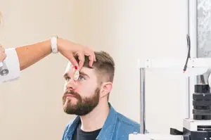 man having his eyes checked by an optometrist