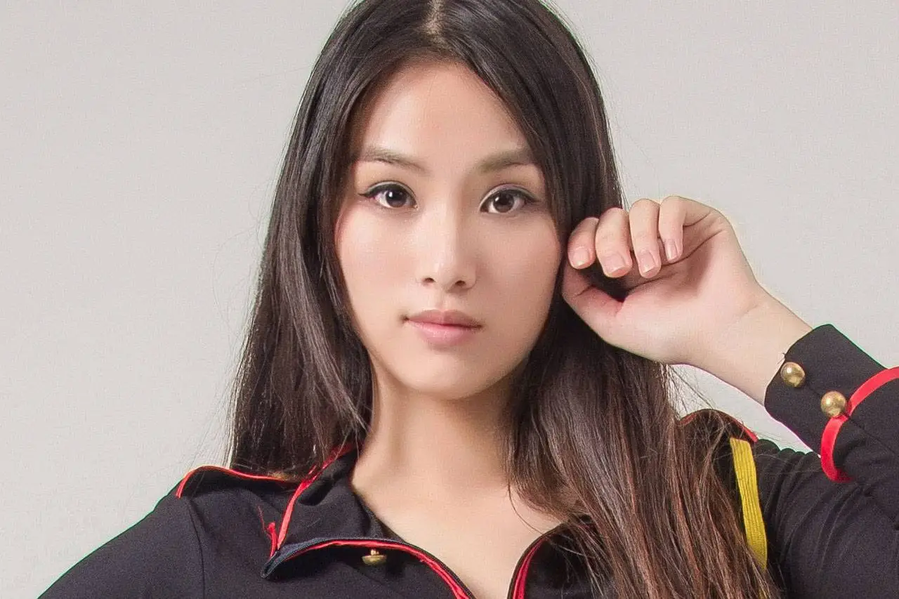 A close up of a woman in a black jacket posing for a photo