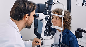 Doctor examining a patient's eye with a slit lamp in an ophthalmology clinic