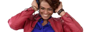 Image of a woman smiling and wearing headphones