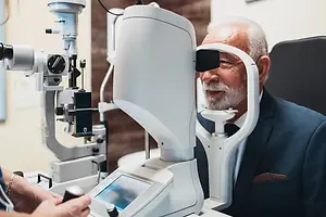 An older man getting his eyes examined in an ophthalmology clinic