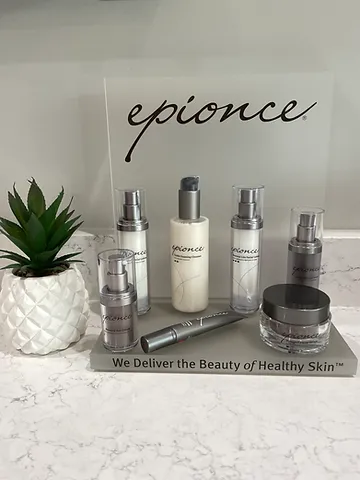 Epionce skincare products displayed beside a potted succulent on a marble counter