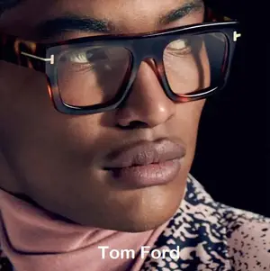 A close-up portrait of a man wearing Tom Ford eyeglasses