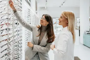 woman at the optical store choosing a new pair of eyeglasses