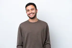 portrait of a smiling man in front of a white wall