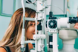 A woman getting an eye exam with an optometrist