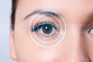 close up of a woman's eye with a blue grid pattern over it