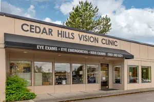 The front of a clinic named Cedar Hills Vision Clinic with a tree and a clear blue sky in the background