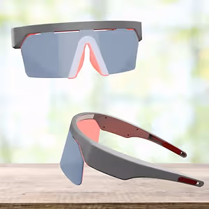 Two pairs of sports goggles with red and grey frames on a wooden surface