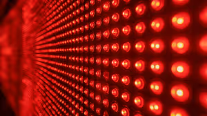 A close-up view of a red LED light panel with a red glow