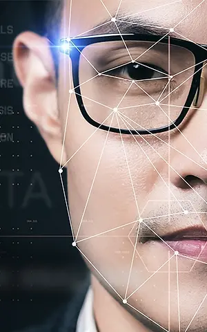 Close-up of a man's face with a light focused on his glasses, overlaid with a network of lines and dots for a futuristic effect