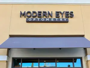 The Modern Eyes Optometry building with a purple awning