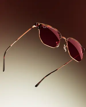 Close up of Ray-Ban RB3658 sunglasses with brown frame and red lenses