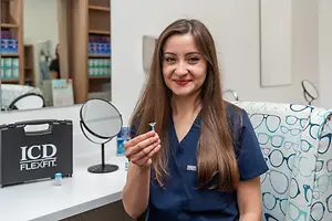 A woman holding a Flexfit contact lens inside an optical shop