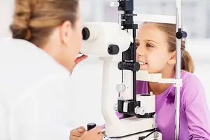 Girl having her eye checked at the optometrist.