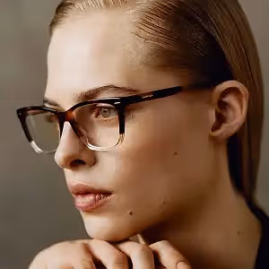 Close up of a woman wearing glasses looking at something off camera