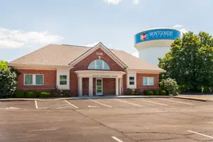 Dayton Opticians Center building with a water tower in the background.