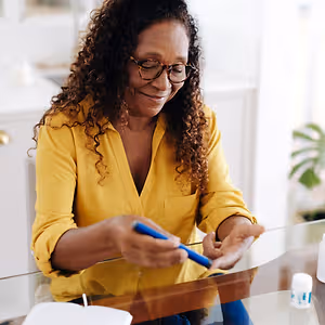 woman managing her diabetes at home