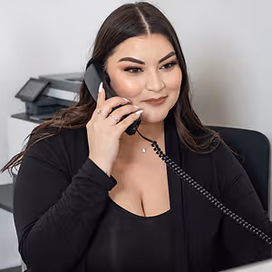 female on the phone sitting at reception