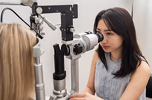 happy asian female doctor eye exam