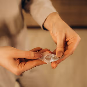 female holding contact lenses on her finger