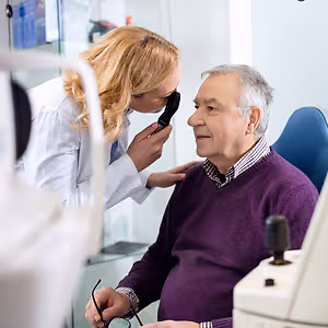elder male eye exam close up