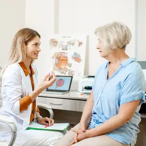 senior woman patient talking with female ophthalmologist
