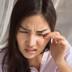 woman rubbing eyes