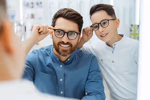 Dad and son trying on frames