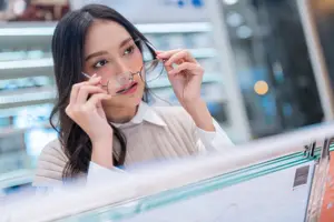 Young woman trying on frames