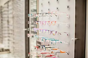 An optical shop with different colored eyeglasses on the wall