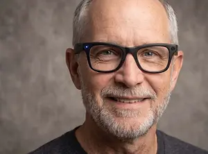 Senior man wearing glasses with smart technology smiling