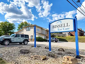 Exterior sign for Bissell Eye Care beside the optometry practice building