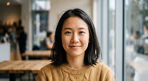 woman smiling at the camera in a coffee shop
