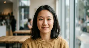woman smiling at the camera in a coffee shop