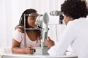 Image of a doctor examining a young girl's eyes